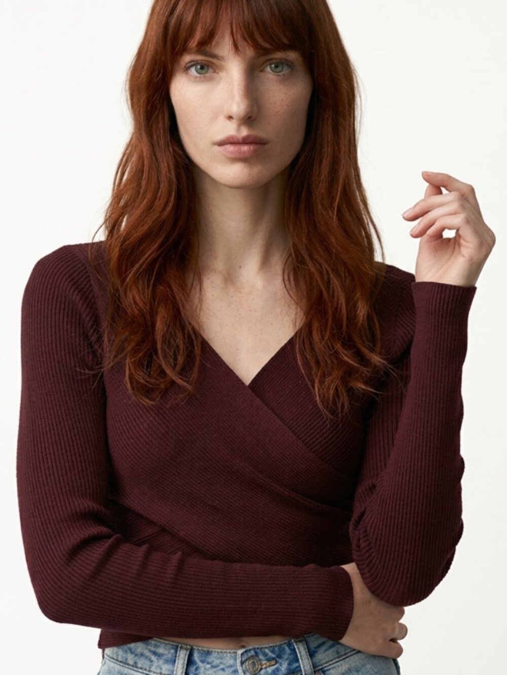 long-sleeve knit sweater featuring a wrap-around front